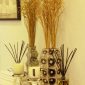 PAIRFUM luxury scented candle and natural reed diffuser in front of mirror with chrome vase in a modern bathroom of a luxurious English home