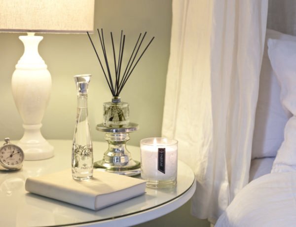 PAIRFUM luxury scented candle, natural reed diffuser and couture perfume room spray on the bedside table in a French chatteau