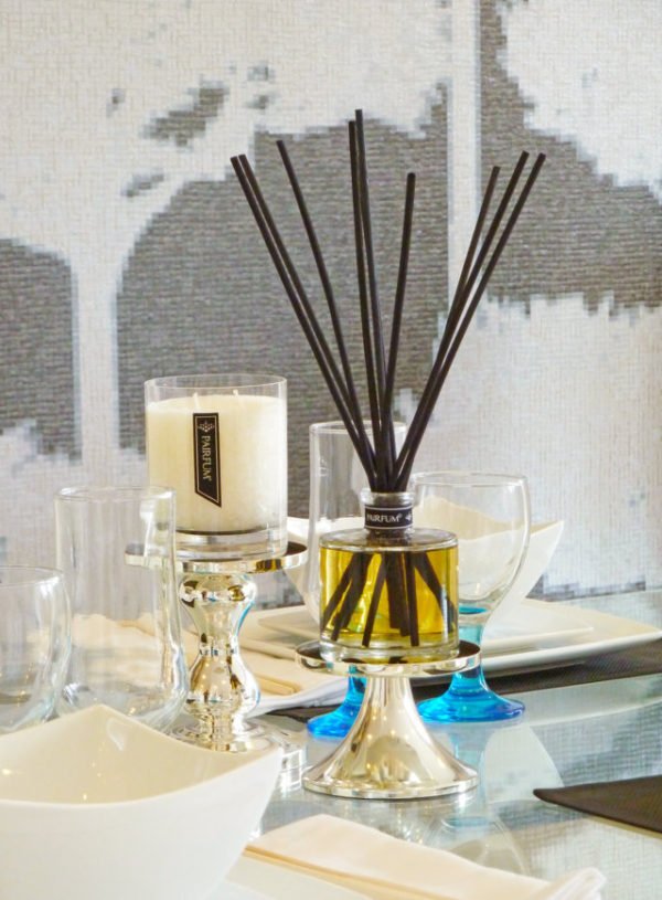 PAIRFUM luxury scented candle and reed diffuser on a dining table