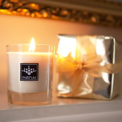 PAIRFUM natural and luxury scented candle as a gift waiting on the fire surround of an English Stately Home